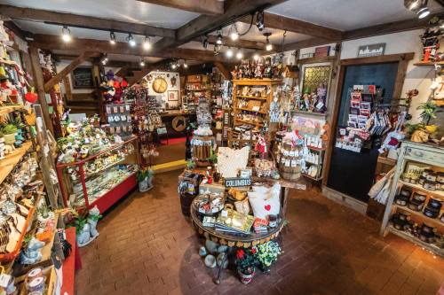 A cozy gift shop filled with various handmade items, decorations, and souvenirs on display. Warm lighting enhances the atmosphere.