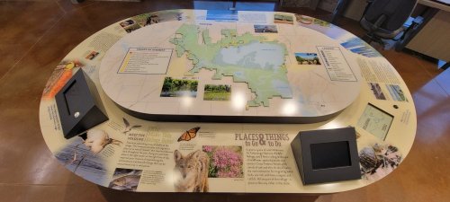 Interactive display table featuring a map and information about local wildlife and habitats.