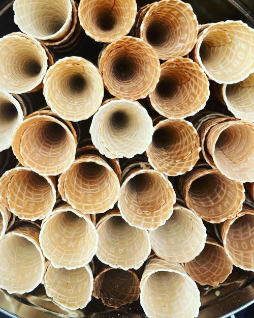 A close-up view of empty ice cream cones stacked in a circular arrangement.