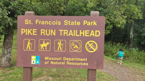 Sign for Pike Run Trailhead at St. Francois State Park, featuring icons for hiking, horseback riding, and biking.