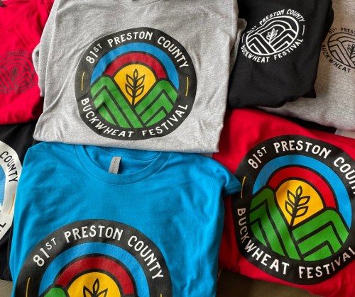 A collection of colorful t-shirts featuring the logo for the 81st Preston County Buckwheat Festival.