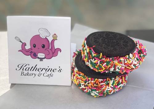 A colorful bakery logo featuring an octopus next to two Oreo cookies coated in sprinkles.