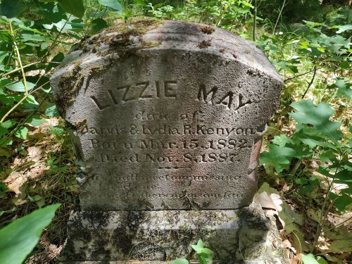 Weathered gravestone of Lizzie May, daughter of Davis and Lydia Kenyon, born March 15, 1882, died November 8, 1887.