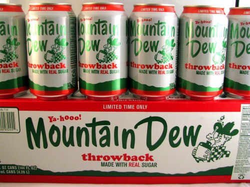Six cans of Mountain Dew Throwback, featuring retro design, stacked on a box with "Limited Time Only" label.