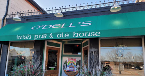 Exterior of O'Dell's Irish Pub & Ale House, featuring a green awning and welcoming entrance.