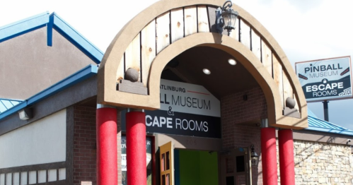 Entrance of a pinball museum and escape rooms, featuring a large archway and colorful columns.