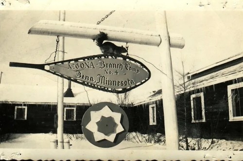Sign for Algona Branch Camp No. 4 in Bena, Minnesota, with a snow-covered background and a decorative star below.