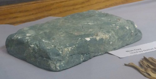 A rectangular block of blue clay displayed on a surface, labeled "Blue Clay Used by Native Peoples."