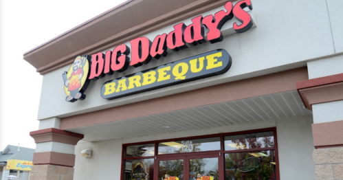 Sign for "Big Daddy's Barbeque" on a restaurant exterior, featuring a cartoon pig logo.