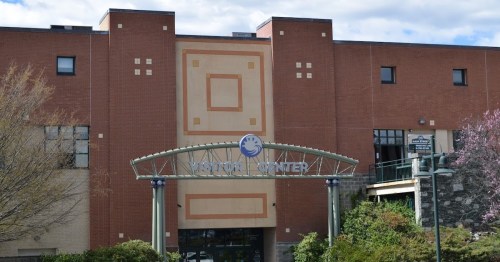 Exterior view of a brick building with a sign reading "National Center" and a decorative archway entrance.