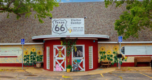 Colorful exterior of the Texas 66 Visitor Center, featuring sunflower murals and a welcoming entrance.