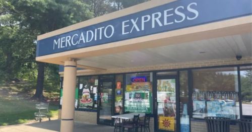 Exterior of Mercadito Express, a small grocery store with a sign and windows displaying various products.