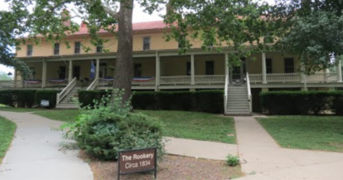 Historic building with a porch, surrounded by greenery, labeled "The Rookery, Circa 1834."