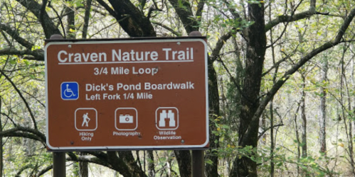 Sign for Craven Nature Trail, indicating a 3/4 mile loop and directions for Dick's Pond Boardwalk.