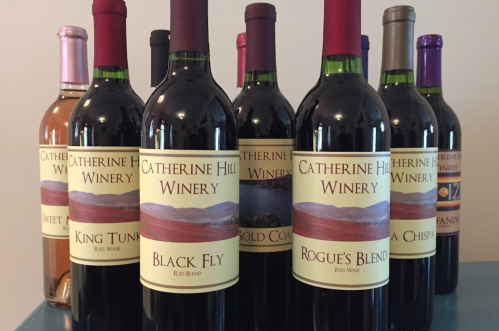 A collection of wine bottles from Catherine Hill Winery, featuring various red blends and a sweet wine.