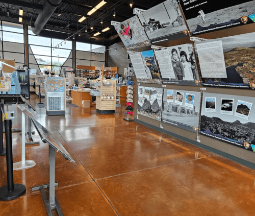 Interior of a visitor center with displays, informational panels, and a retail area featuring natural history exhibits.