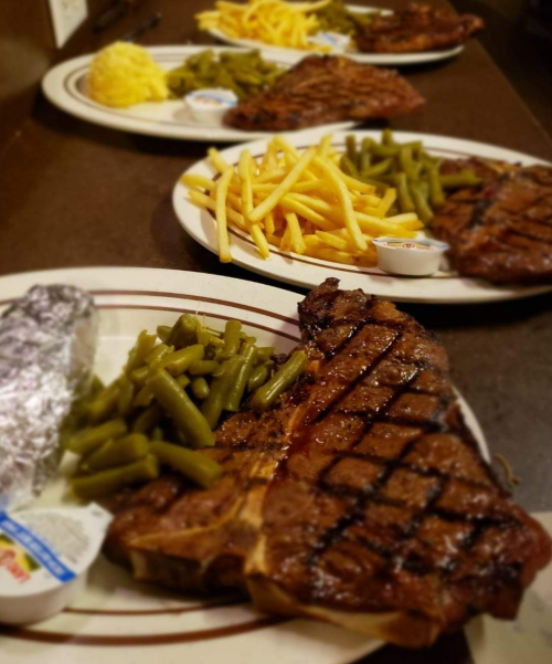 Three plates of food featuring grilled steak, green beans, French fries, and a baked potato with dipping sauce.