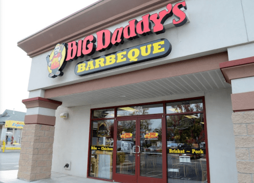 Exterior of Big Daddy's Barbeque restaurant, featuring a colorful sign and large windows.