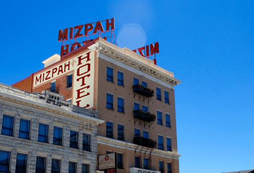 Historic Mizpah Hotel building with a bright blue sky and vintage signage.