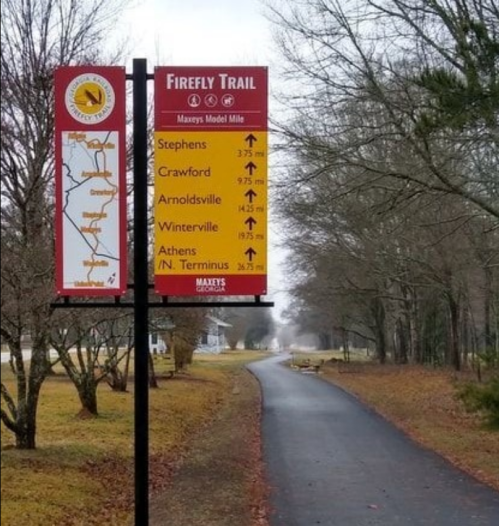 Signpost for the Firefly Trail showing distances to various locations: Stephens, Crawford, Arnoldsville, Winterville, Athens.
