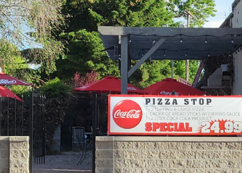 A pizza restaurant sign advertising a special: large pizza, breadsticks, and a 2-liter soda for $24.99.