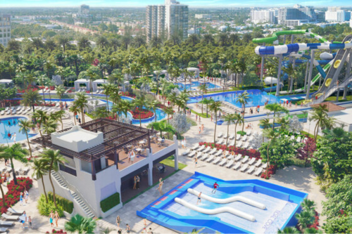 Aerial view of a vibrant water park with pools, slides, and lush landscaping, surrounded by palm trees and lounge chairs.