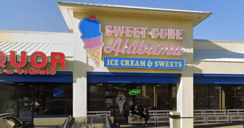 Sign for "Sweet Cone Alabama Ice Cream & Sweets" with an ice cream cone graphic, located in a shopping plaza.