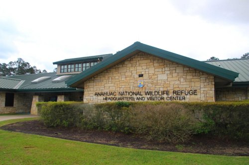 Building exterior of the Anahuac National Wildlife Refuge headquarters and visitor center, featuring stone walls and a green roof.