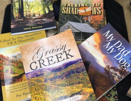 A collection of books displayed on a surface, featuring titles related to nature and personal stories.
