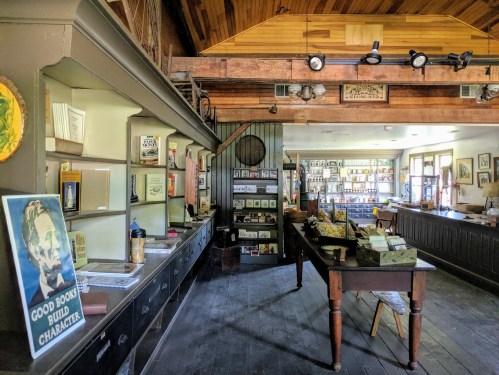 Interior of a cozy bookstore with wooden shelves, books on display, and a warm, inviting atmosphere.