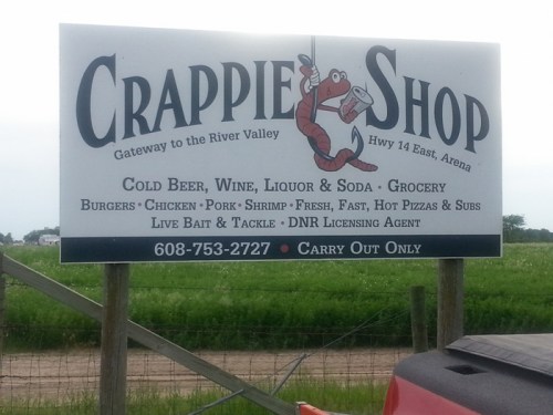 Sign for Crappie Shop featuring food and drink options, located on Hwy 14 East, Arena. Carry out only.