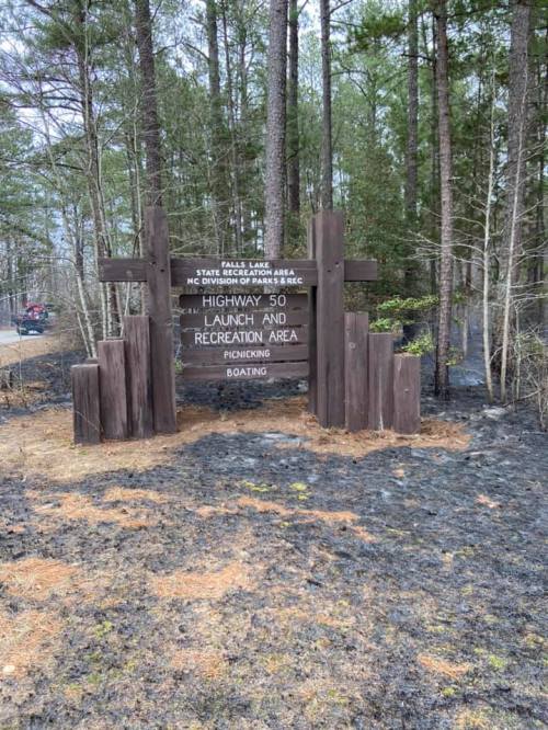 Sign for Highway 50 Launch and Recreation Area, surrounded by trees and scorched earth from a recent fire.