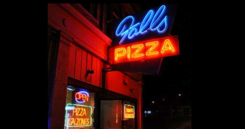 Neon sign for Falls Pizza, featuring "Open" and "Pizza" in bright colors against a dark background.