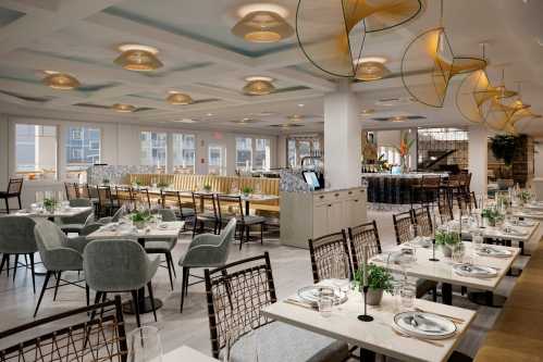 Modern restaurant interior featuring elegant seating, stylish decor, and large windows for natural light.