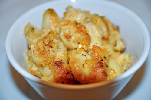 A bowl of baked macaroni and cheese with a golden, crispy topping.