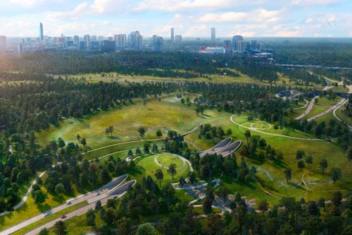 Aerial view of a green park with winding paths, trees, and a city skyline in the background under a blue sky.