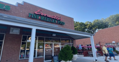 Exterior of Ernesto's Fine Mexican Food restaurant, featuring a brick facade and outdoor seating area.