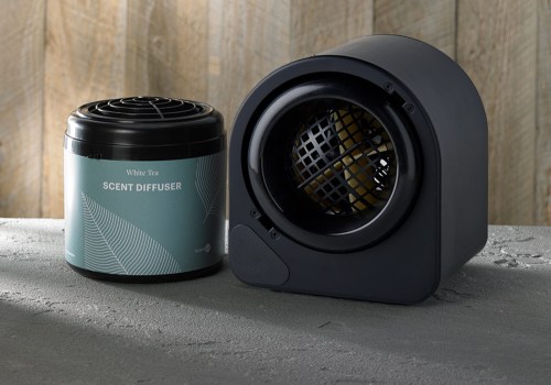 A black scent diffuser next to a cylindrical container labeled "Scent Diffuser" on a textured surface.