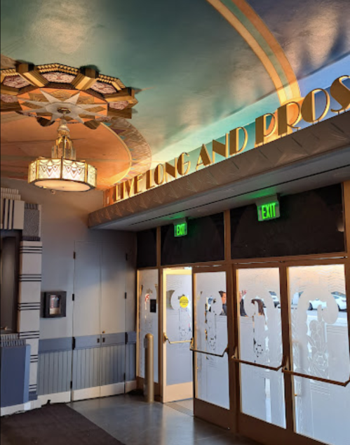 Interior view featuring a decorative ceiling and a sign that reads "LIVE LONG AND PROSPER" above double doors.