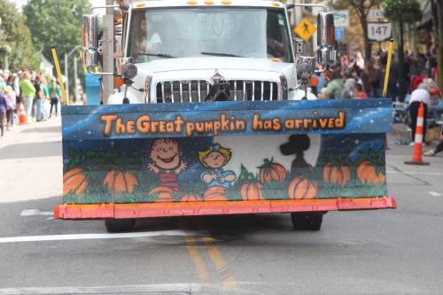 A parade float featuring cartoon characters and pumpkins, with the text "The Great pumpkin has arrived" displayed prominently.