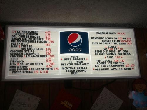 Menu board featuring burgers, sandwiches, salads, and drinks, with prices listed for each item. Pepsi logo included.