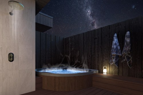 A serene outdoor spa area at night, featuring a hot tub, shower, and towels, under a starry sky.