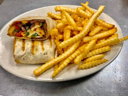 A plate with a wrapped burrito and a side of golden crinkle-cut fries.