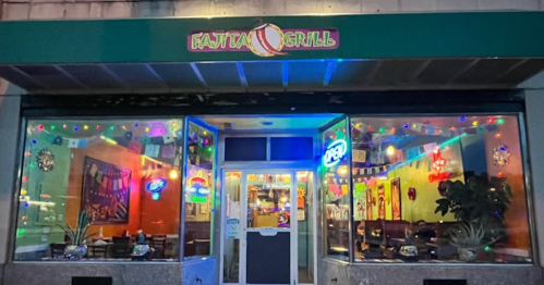 Exterior of Fajita Grill restaurant, brightly lit with colorful decorations and a welcoming entrance.