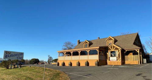 A wooden restaurant building with a sign reading "Bavarian Chef," set against a clear blue sky.