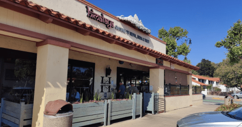Exterior of a restaurant named "Himalaya," featuring a patio and a clear blue sky in the background.