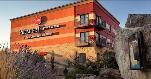 Exterior view of the Premier Best Western Hotel in Helena, featuring a red and beige facade and balconies.