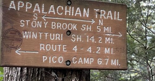 Wooden signpost indicating directions and distances for the Appalachian Trail and nearby locations.