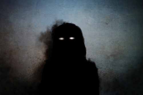 A dark silhouette of a figure with glowing white eyes against a textured, moody background.