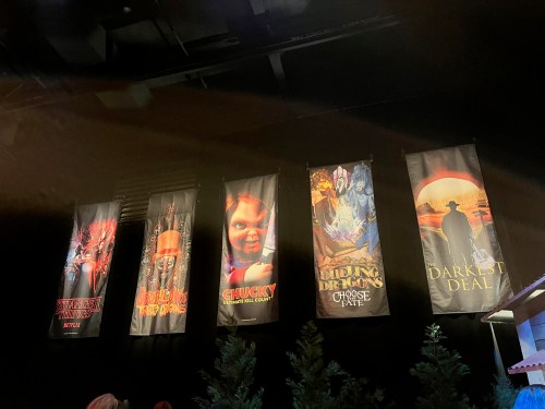 Five banners featuring horror-themed artwork, including "Stranger Things," "Chucky," and "The Darkest Deal."